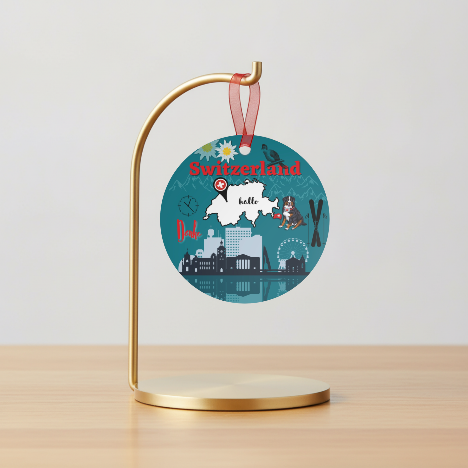 Decorative round sign with Switzerland map and landmarks on a gold stand against a light gray background.