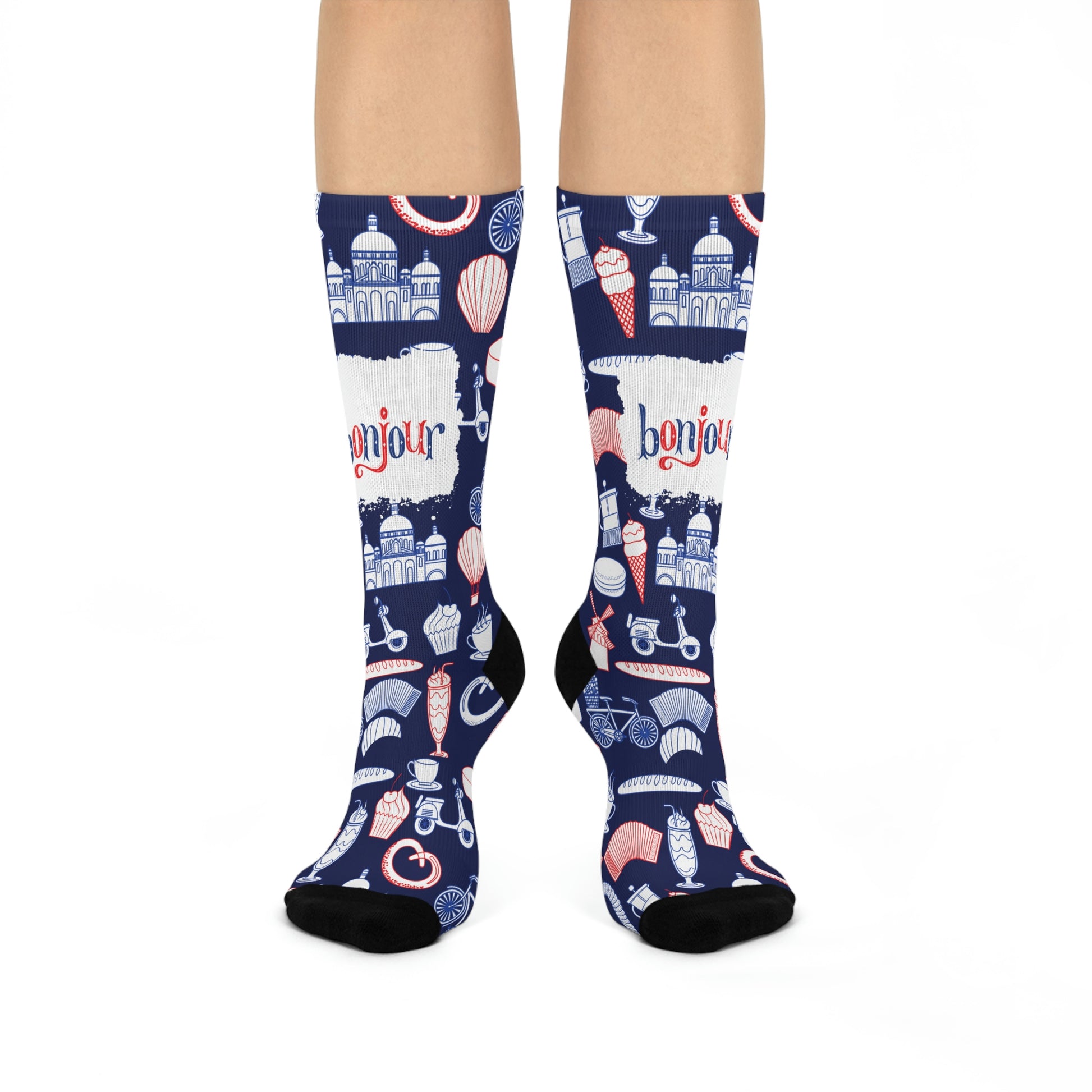A pair of blue and navy colored socks with a design featuring French motifs such as the Eiffel Tower, a chocolate dessert, and other cultural elements.
