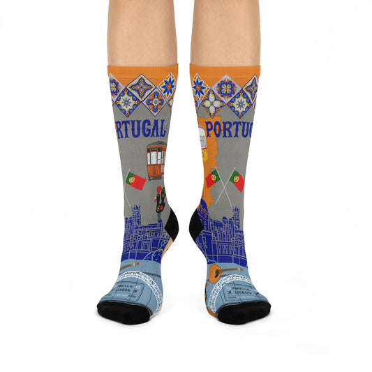 A pair of mid-calf socks with a design featuring the Portuguese flag and symbols related to Lisbon on a grey background.