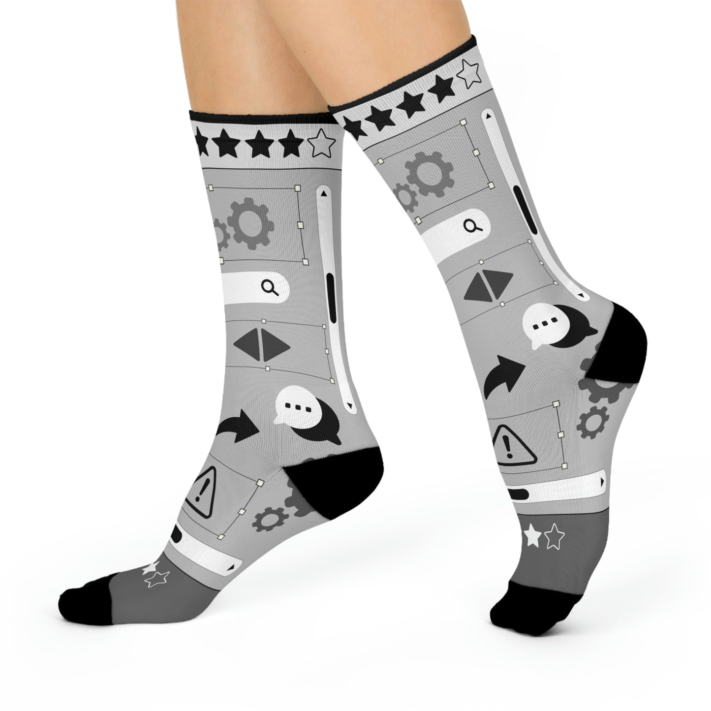 A pair of gray socks with a design of stars, gears, and other graphic elements related to user experience (UX) design.